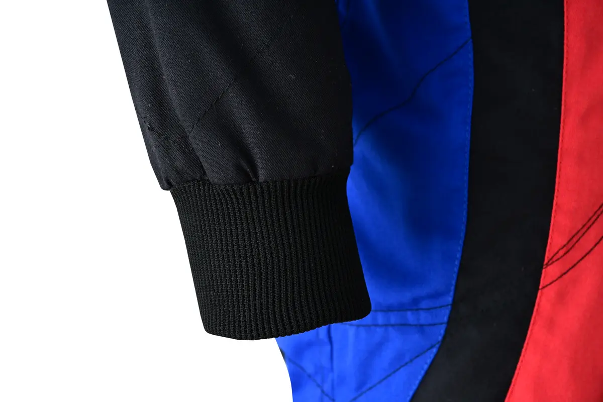 Close-up of a black knitted rib cuff and blue and red sleeve panels